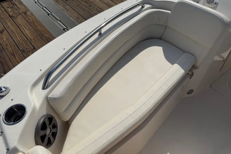 Slide: The Image of 2019 Grady-White Freedom 255 boat interior with cushioned seating and cup holder. - 17