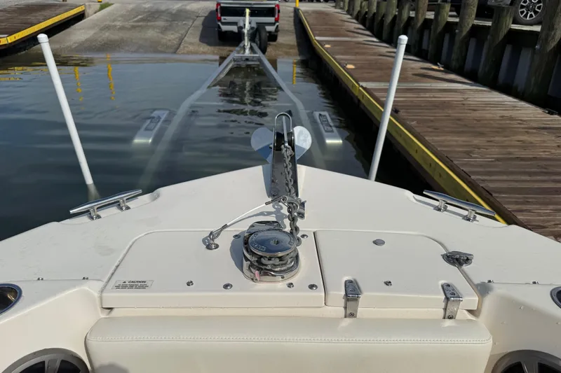 Slide: The Image of 2019 Grady-White Freedom 255 boat being launched from a trailer at a dock. - 19