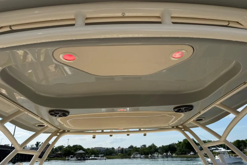 Slide: The Image of 2019 Grady-White Freedom 255 boat canopy with red lights and speakers. - 22