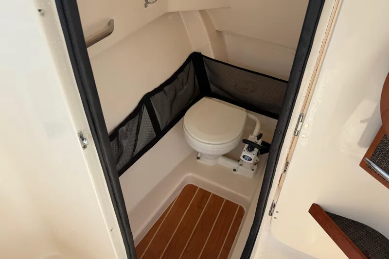 Slide: The Image of 2019 Grady-White Freedom 255 boat interior with compact marine toilet. - 24