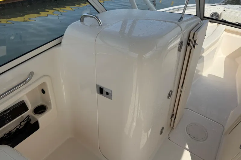 Slide: The Image of 2019 Grady-White Freedom 255 boat interior with storage compartment and seating area. - 25