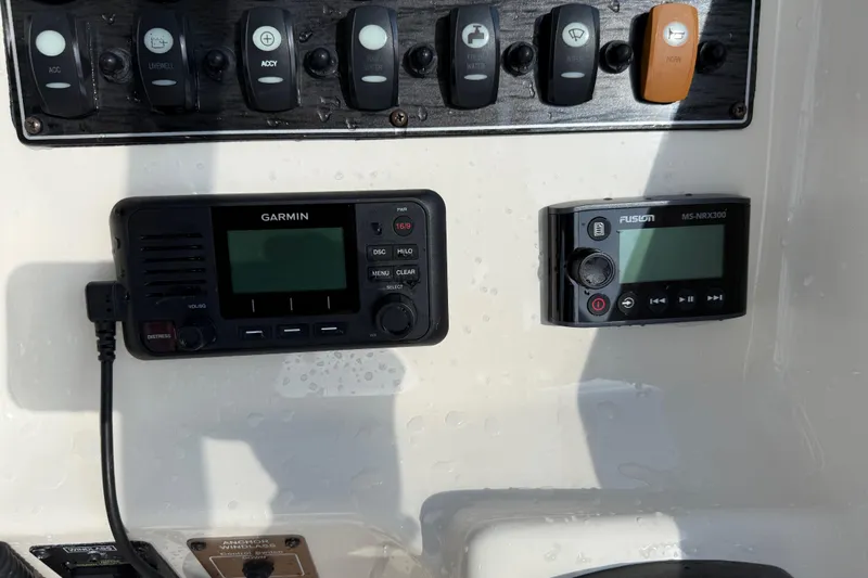 Slide: The Image of Control panel of a 2019 Grady-White Freedom 255 boat with Garmin and Fusion devices. - 28