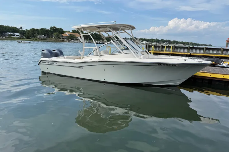 Slide: The Image of 2019 Grady-White Freedom 255 boat docked on calm water. - 3