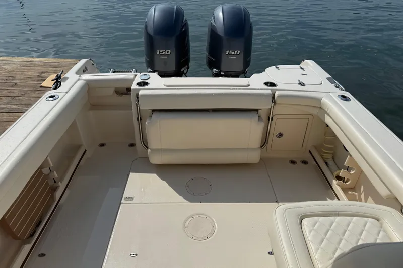 Slide: The Image of 2019 Grady-White Freedom 255 boat interior with twin 150 engines at dock. - 35
