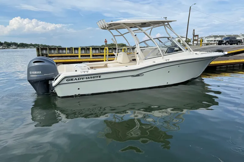 Slide: The Image of 2019 Grady-White Freedom 255 boat with Yamaha engine docked on calm water. - 5
