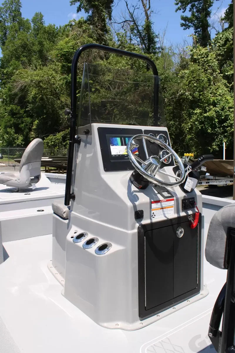 Slide: The Image of 2026 G3 Bay 21 GX boat console with steering wheel and controls. - 11
