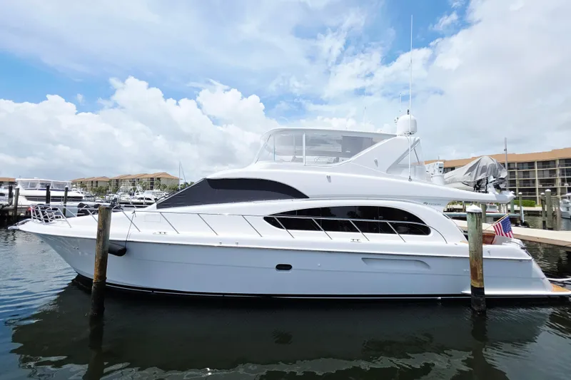 The Image of 2008 Hatteras 64 Motor Yacht docked at marina under blue sky. - 0