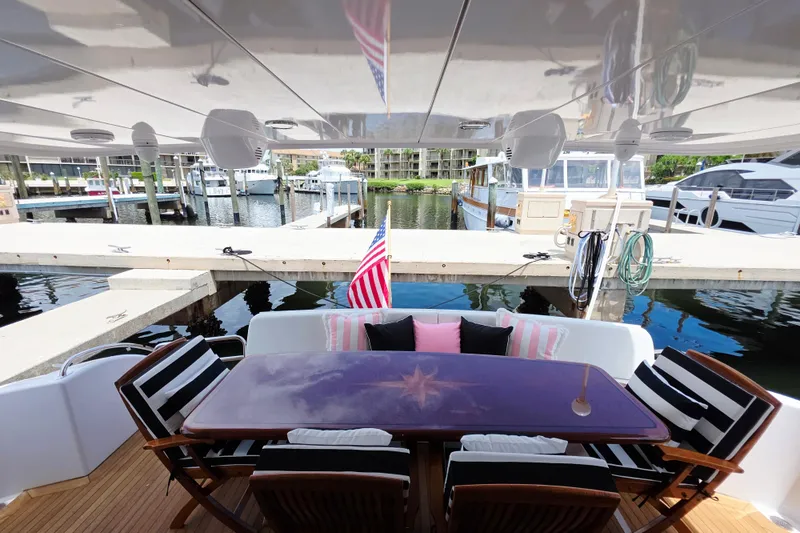 Slide: The Image of Outdoor seating area on 2008 Hatteras 64 Motor Yacht, docked with marina view. - 12