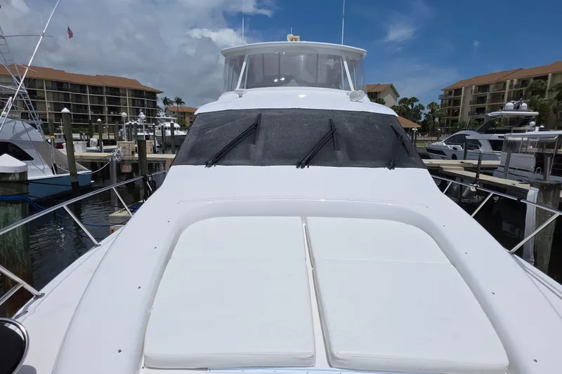 Slide: The Image of 2008 Hatteras 64 Motor Yacht docked at marina under clear blue sky. - 15