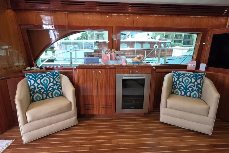 Slide: The Image of Luxurious 2008 Hatteras 64 Motor Yacht interior with elegant seating and wood finishes. - 20