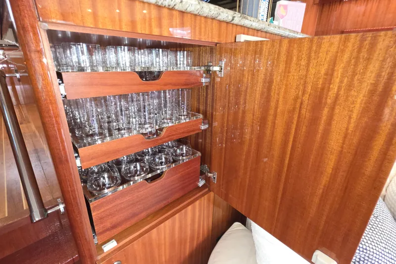 Slide: The Image of Luxurious wooden cabinet with glassware on a 2008 Hatteras 64 Motor Yacht. - 24