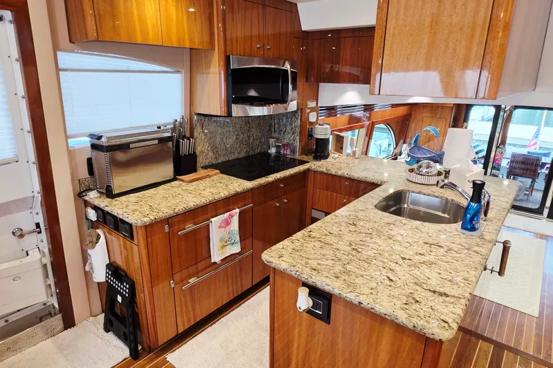 Slide: The Image of Luxurious kitchen interior of a 2008 Hatteras 64 Motor Yacht with granite countertops. - 28