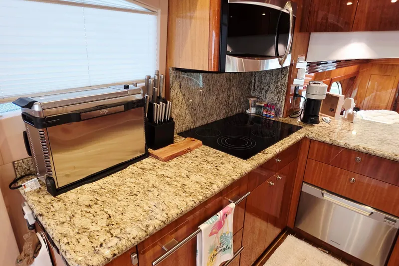 Slide: The Image of Luxurious kitchen in 2008 Hatteras 64 Motor Yacht with granite countertops and modern appliances. - 29