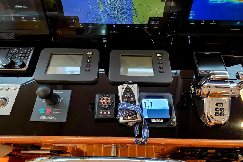 Slide: The Image of Control panel of a 2008 Hatteras 64 Motor Yacht with navigation and monitoring systems. - 34