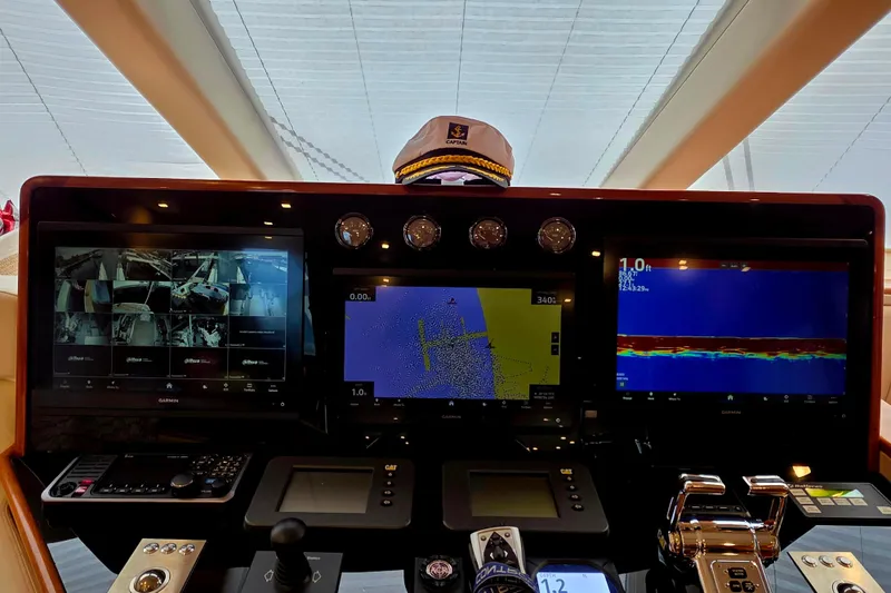 Slide: The Image of Helm of 2008 Hatteras 64 Motor Yacht with navigation screens and captain's hat. - 35