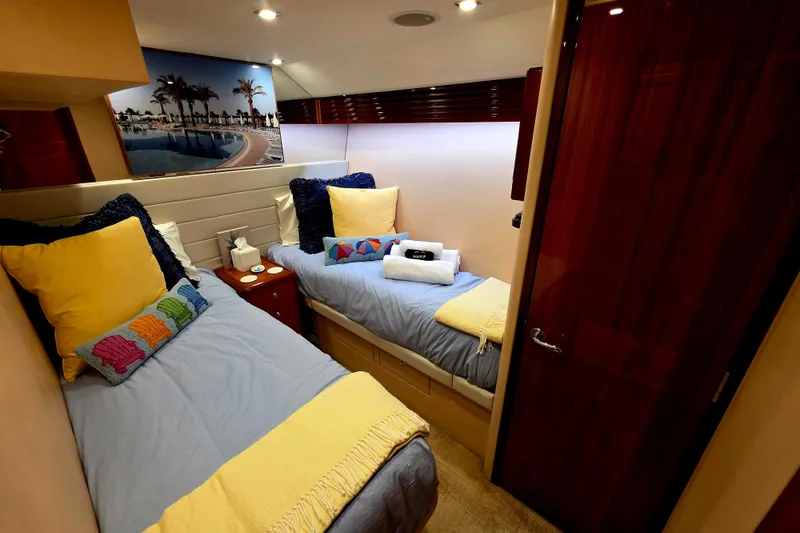 Slide: The Image of Luxurious twin cabin in a 2008 Hatteras 64 Motor Yacht with cozy bedding. - 39