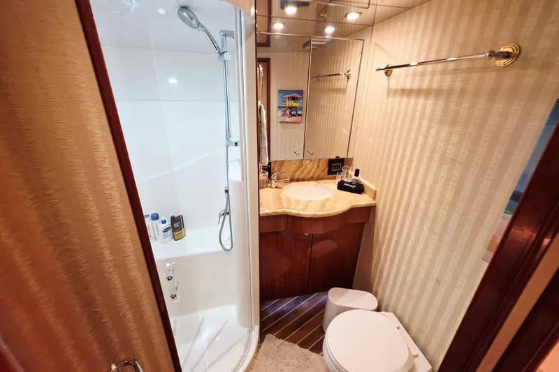 Slide: The Image of Luxurious bathroom in 2008 Hatteras 64 Motor Yacht with shower, vanity, and toilet. - 41