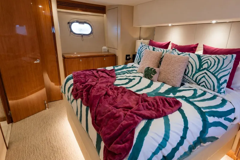 Slide: The Image of Luxurious bedroom in 2008 Hatteras 64 Motor Yacht with stylish bedding and wood accents. - 43