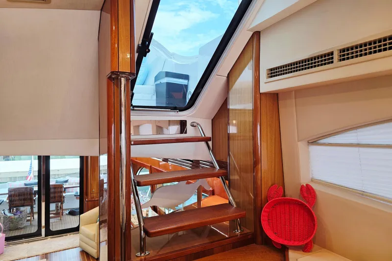 Slide: The Image of Interior of 2008 Hatteras 64 Motor Yacht with wooden stairs and skylight. - 46