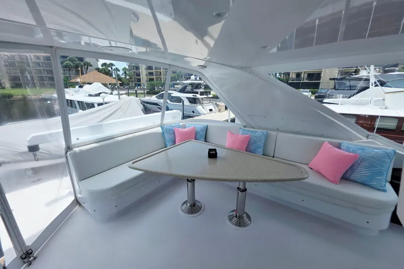 Slide: The Image of Luxurious 2008 Hatteras 64 Motor Yacht interior with elegant seating and vibrant cushions. - 48