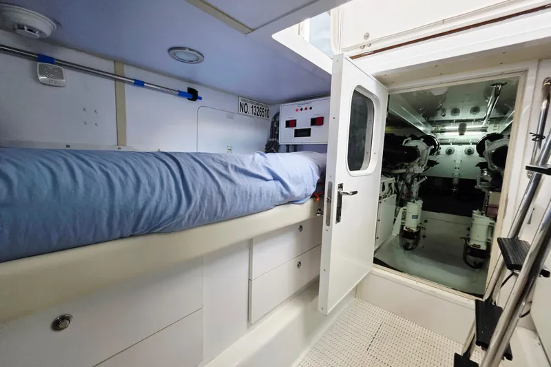 Slide: The Image of 2008 Hatteras 64 Motor Yacht interior with bunk bed and engine room access. - 52
