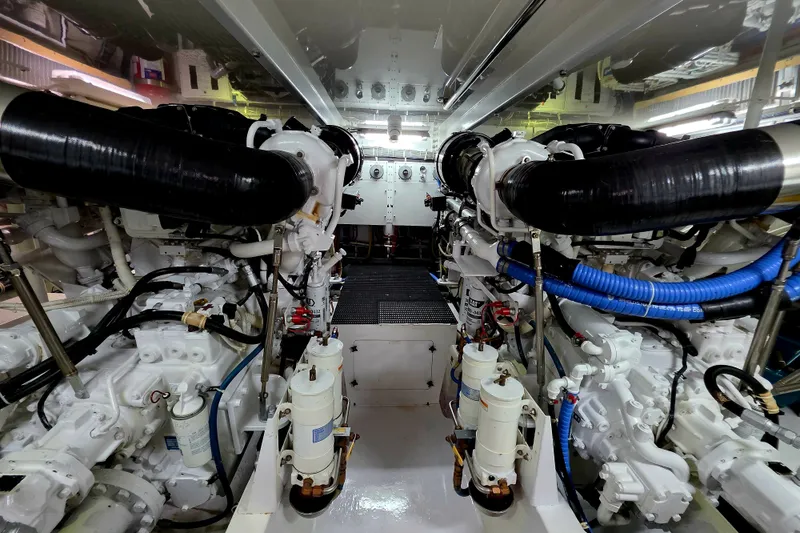 Slide: The Image of Engine room of a 2008 Hatteras 64 Motor Yacht, showcasing dual engines and mechanical systems. - 53