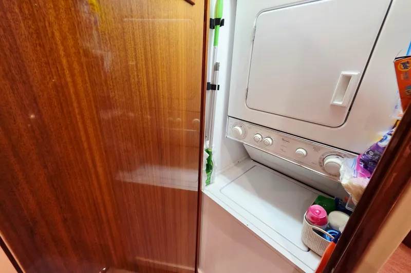 Slide: The Image of Laundry area with stacked washer-dryer in 2008 Hatteras 64 Motor Yacht. - 58