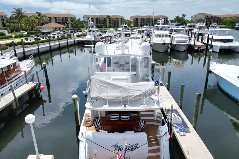 Slide: The Image of 2008 Hatteras 64 Motor Yacht docked in a marina with other boats. - 6