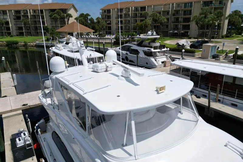 Slide: The Image of 2008 Hatteras 64 Motor Yacht docked at marina with other luxury boats. - 7