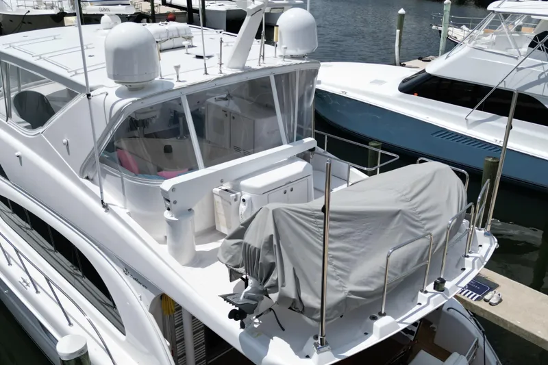 Slide: The Image of 2008 Hatteras 64 Motor Yacht docked, featuring covered equipment on the upper deck. - 8