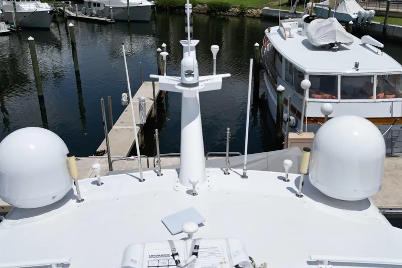 Slide: The Image of 2008 Hatteras 64 Motor Yacht docked, featuring advanced navigation equipment and sleek design. - 9