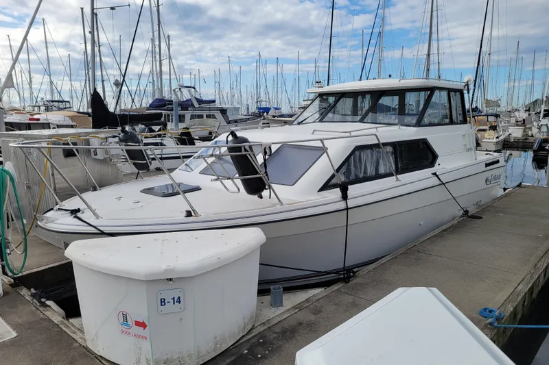 The Image of 1993 Bayliner 2859 Ciera Classic docked at marina, surrounded by other boats. - 0