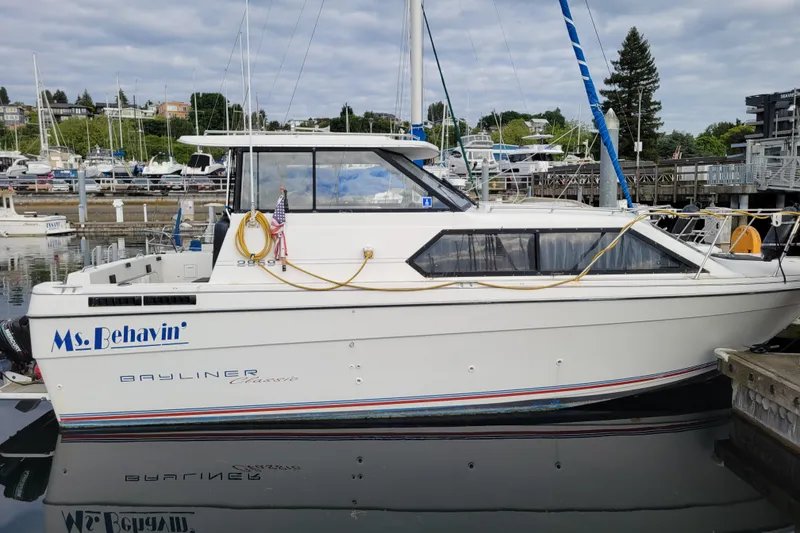 Slide: The Image of 1993 Bayliner 2859 Ciera Classic boat docked at marina, named "Ms. Behavin'." - 1