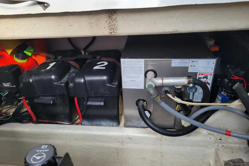 Slide: The Image of Battery compartment of a 1993 Bayliner 2859 Ciera Classic boat, showing two batteries and wiring. - 14