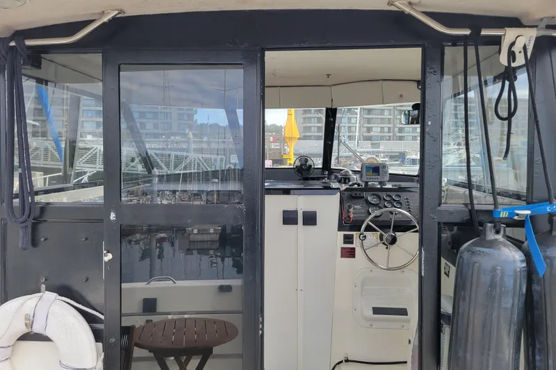 Slide: The Image of Interior view of a 1993 Bayliner 2859 Ciera Classic boat cockpit with steering wheel and controls. - 2