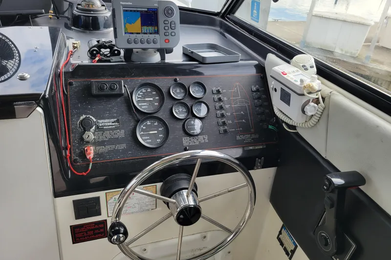 Slide: The Image of 1993 Bayliner 2859 Ciera Classic dashboard with steering wheel, gauges, and navigation equipment. - 3