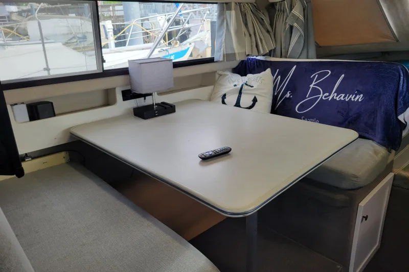 Slide: The Image of Interior of 1993 Bayliner 2859 Ciera Classic with table, cushions, and nautical decor. - 8