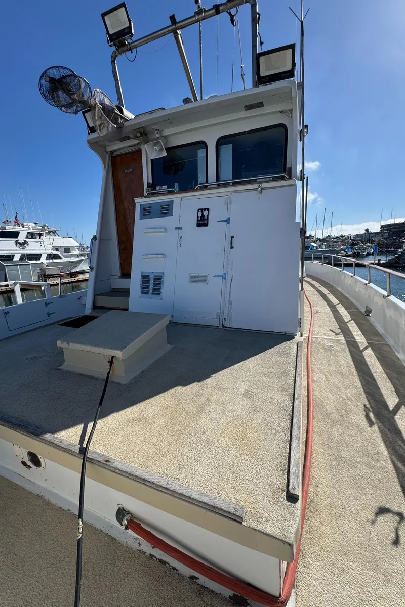 Slide: The Image of 1966 Seaway Commercial Sportfish Vessel docked, featuring spacious deck and cabin, ideal for fishing. - 10