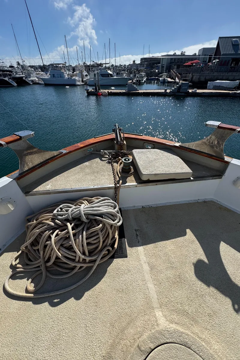 Slide: The Image of 1966 Seaway Commercial Sportfish Vessel docked, featuring coiled ropes and marina backdrop. - 12