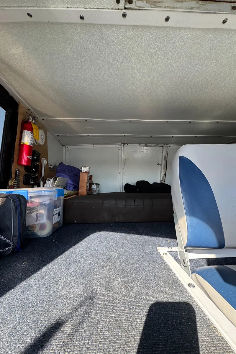 Slide: The Image of Interior of a 1966 Seaway Commercial Sportfish Vessel, featuring seating and storage. - 15
