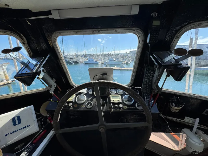 Slide: The Image of 1966 Seaway Commercial Sportfish Vessel cockpit with steering wheel, navigation equipment, and marina view. - 19