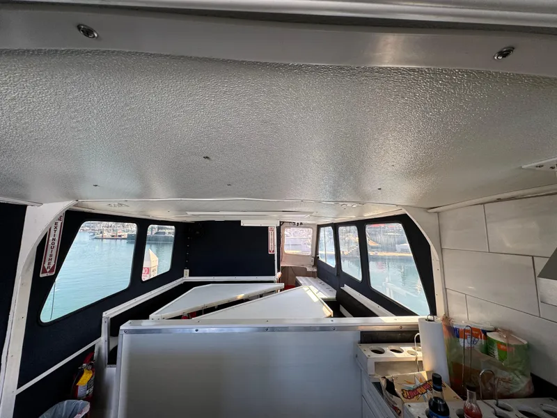 Slide: The Image of Interior of a 1966 Seaway Commercial Sportfish Vessel, featuring windows and storage areas. - 22