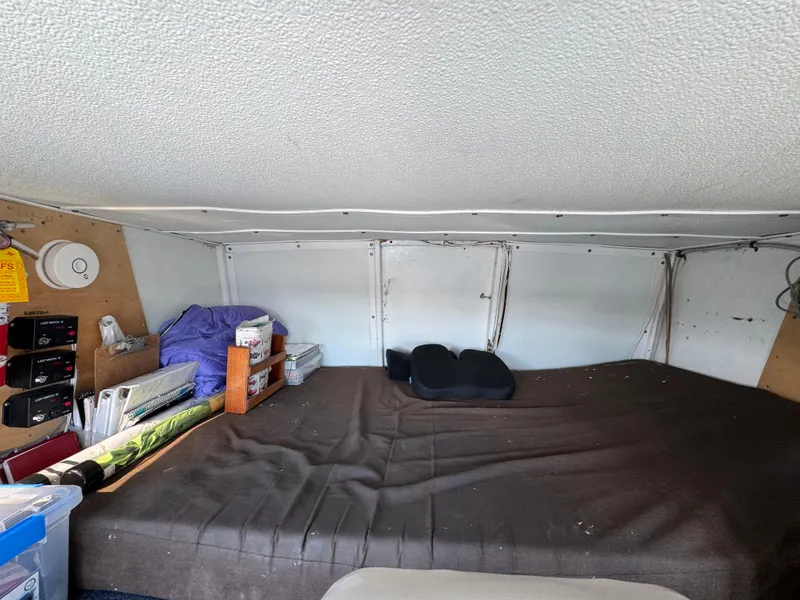 Slide: The Image of Interior cabin of a 1966 Seaway Commercial Sportfish Vessel, featuring a bed and storage area. - 24