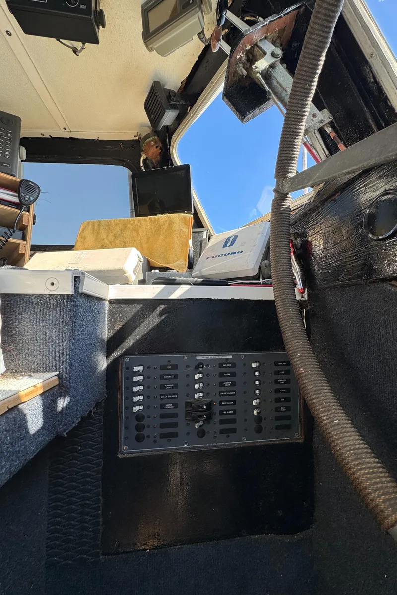 Slide: The Image of Interior of a 1966 Seaway Commercial Sportfish Vessel cockpit, featuring control panel and steering wheel. - 25