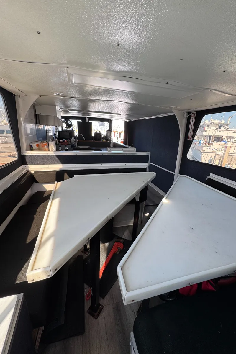 Slide: The Image of Interior of 1966 Seaway Commercial Sportfish Vessel, featuring seating and tables. - 30
