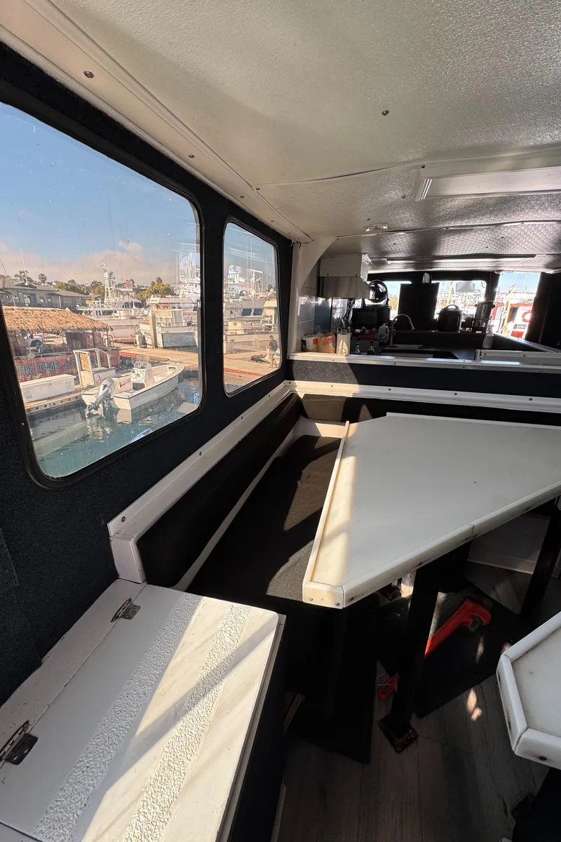 Slide: The Image of Interior of a 1966 Seaway Commercial Sportfish Vessel, featuring seating and large windows. - 31