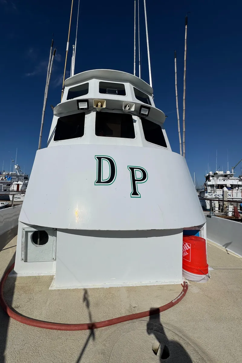 Slide: The Image of 1966 Seaway Commercial Sportfish Vessel with COI, docked, clear sky background. - 9