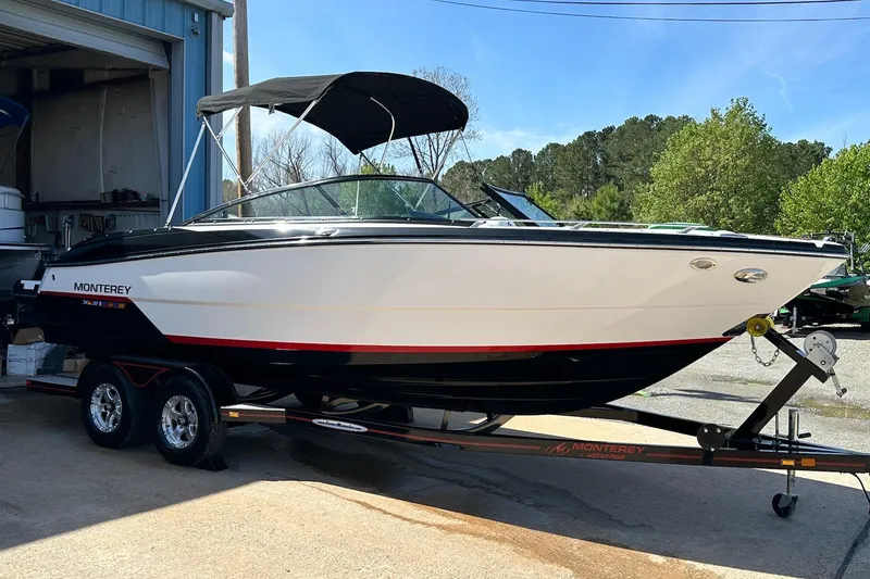 The Image of 2016 Monterey 238SS Super Sport boat on trailer, parked outdoors near a building. - 0