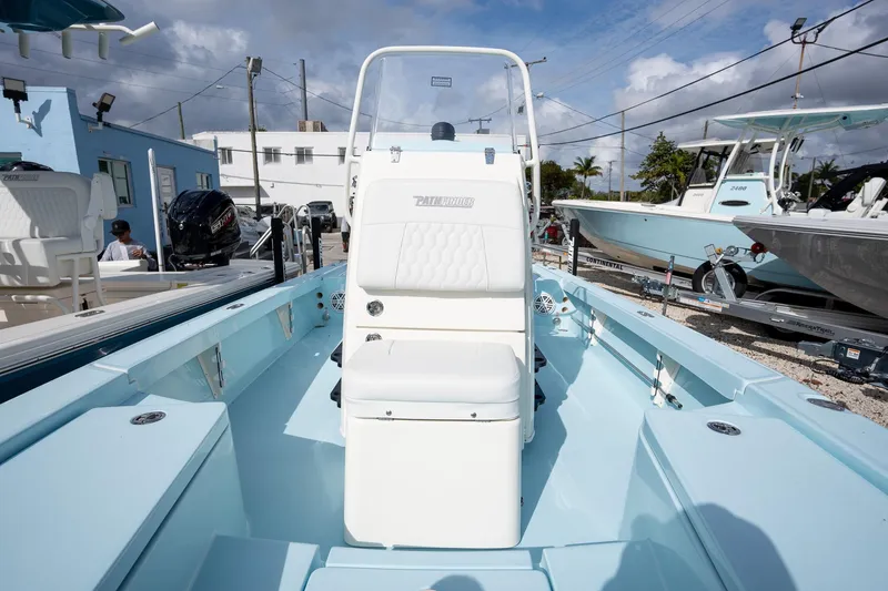 Slide: The Image of 2025 Pathfinder 2300 HPS boat with white seating, displayed outdoors under a cloudy sky. - 13