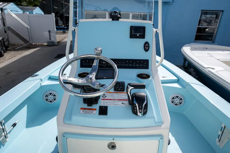 Slide: The Image of 2025 Pathfinder 2300 HPS boat dashboard with steering wheel and controls. - 14